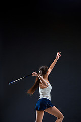 Image showing Portrait of beautiful girl tennis player with a racket on dark background