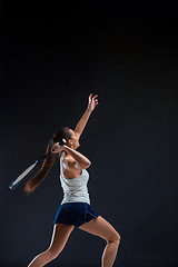 Image showing Portrait of beautiful girl tennis player with a racket on dark background