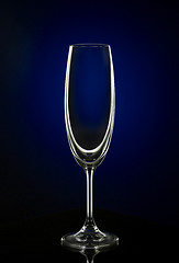 Image showing Empty wine glass on dark red