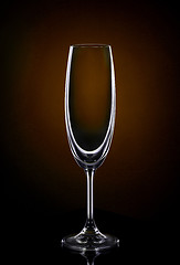 Image showing Empty wine glass on dark red