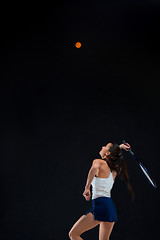 Image showing Portrait of beautiful girl tennis player with a racket on dark background