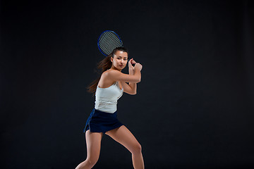 Image showing Portrait of beautiful girl tennis player with a racket on dark background