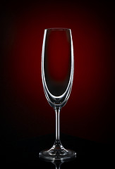 Image showing Empty wine glass on dark red