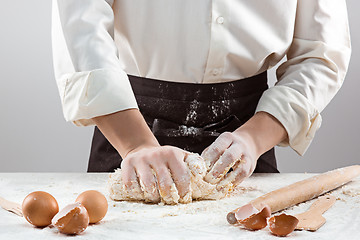 Image showing Hands kneading a dough