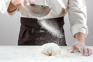 Image showing Hands kneading a dough