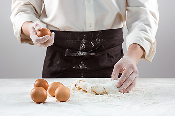 Image showing Hands kneading a dough