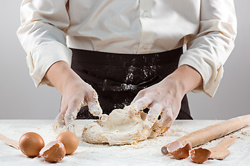 Image showing Hands kneading a dough