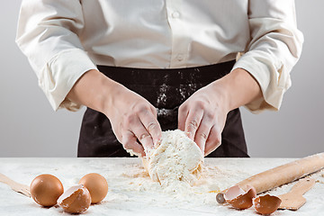 Image showing Hands kneading a dough