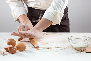 Image showing Hands kneading a dough