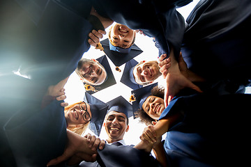 Image showing happy students or bachelors in mortar boards