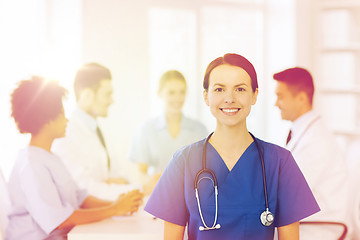 Image showing happy doctor over group of medics at hospital