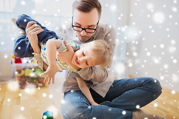 Image showing father and son playing and having fun at home