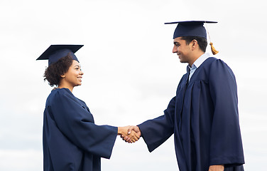 Image showing happy students or bachelors greeting each other