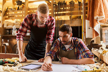 Image showing workmen with tablet pc and blueprint at workshop