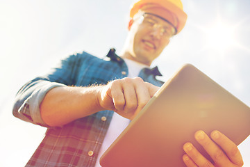 Image showing close up of builder in hardhat with tablet pc