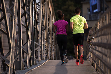 Image showing multiethnic couple jogging in the city