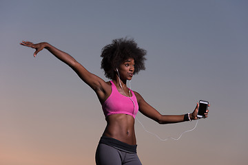 Image showing young black girl dances outdoors