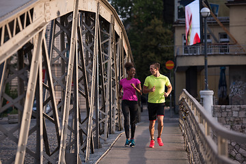 Image showing multiethnic couple jogging in the city