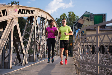 Image showing multiethnic couple jogging in the city