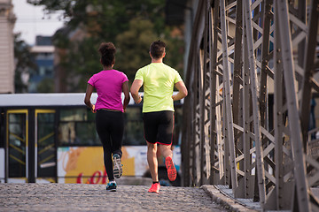 Image showing multiethnic couple jogging in the city