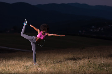 Image showing black woman doing yoga  in the nature