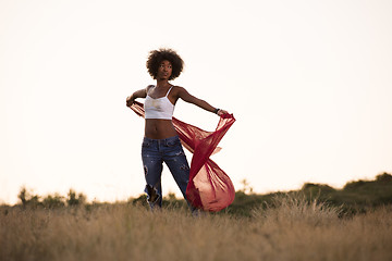 Image showing black girl dances outdoors in a meadow