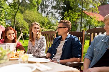 Image showing happy friends having dinner at summer garden party