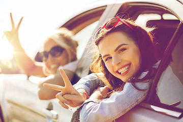 Image showing happy teenage girls or women in car at seaside