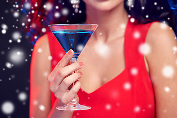 Image showing close up of beautiful woman with cocktail at night