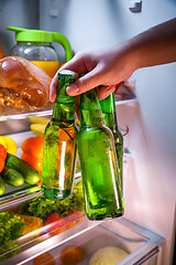 Image showing Man taking beer from a fridge