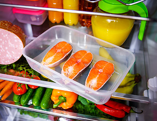 Image showing Raw Salmon steak in the open refrigerator