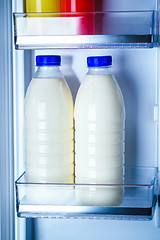 Image showing Bottles of milk in the fridge