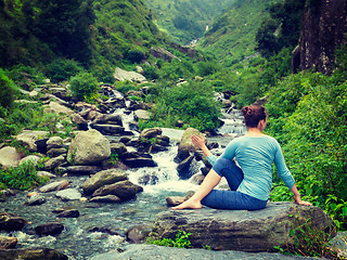 Image showing Woman doing Ardha matsyendrasana asana outdoors