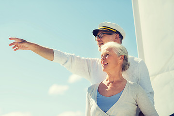 Image showing happy senior couple on sail boat or yacht in sea