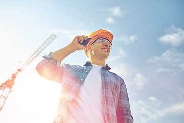 Image showing close up of builder in hardhat with walkie talkie