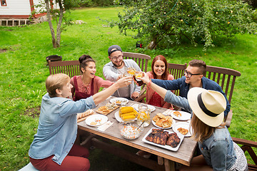 Image showing happy friends having dinner at summer garden party