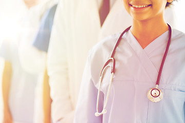 Image showing close up of happy doctor or nurse with stethoscope