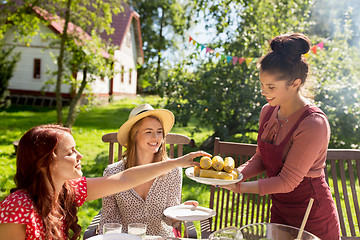 Image showing happy friends having dinner at summer garden party