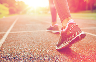 Image showing close up of woman feet running on track from back