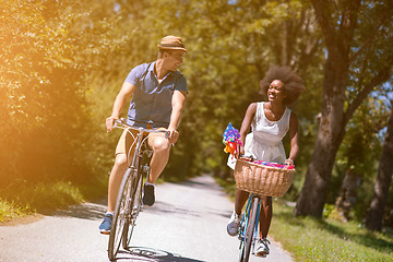 Image showing Young multiethnic couple having a bike ride in nature