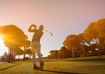 Image showing golf player hitting shot with club