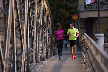 Image showing multiethnic couple jogging in the city