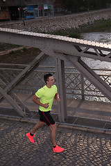 Image showing a young man jogging in the city