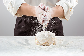 Image showing Hands kneading a dough