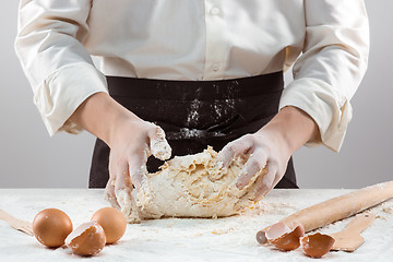 Image showing Hands kneading a dough