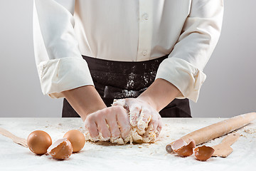 Image showing Hands kneading a dough