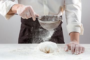 Image showing Hands kneading a dough