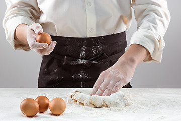 Image showing Hands kneading a dough