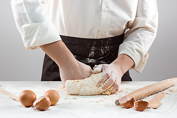 Image showing Hands kneading a dough