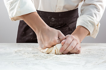 Image showing Hands kneading a dough